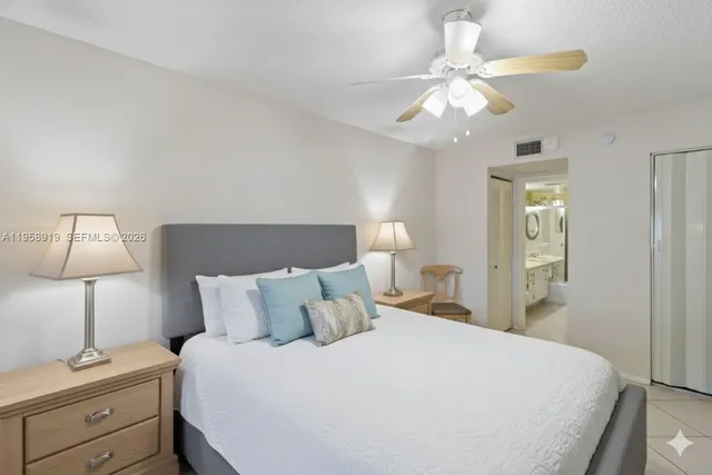 a bedroom with a bed and a lamp