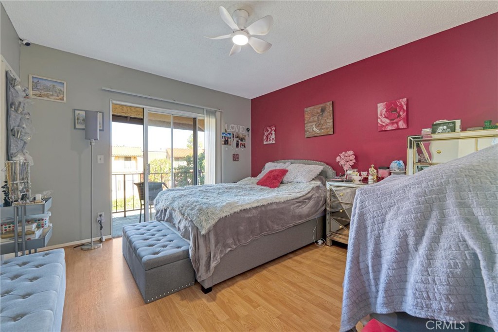 19545 Sherman Way, Unit 97 Reseda, CA 91335 - Photo 11 of 26 a bedroom with a large bed and a couch