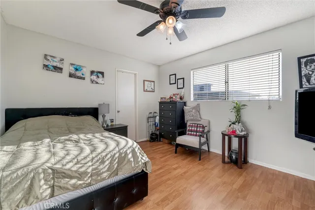a bedroom with a bed and a flat tv screen
