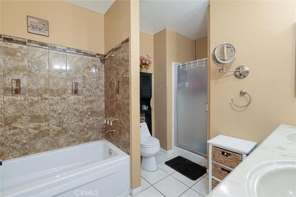 19545 Sherman Way, Unit 97 Reseda, CA 91335 - Photo 14 of 26 a bathroom with a bathtub and a shower