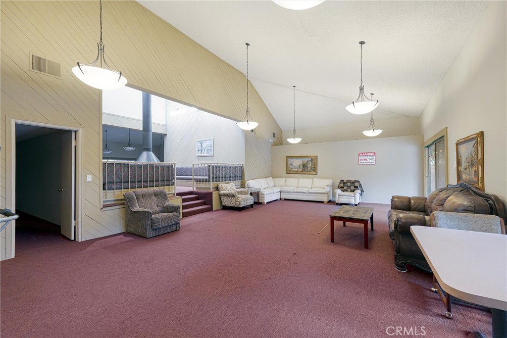 19545 Sherman Way, Unit 97 Reseda, CA 91335 - Photo 22 of 26 a living room with furniture and a chandelier