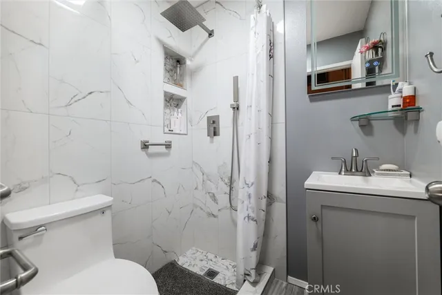 a bathroom with a toilet sink and shower