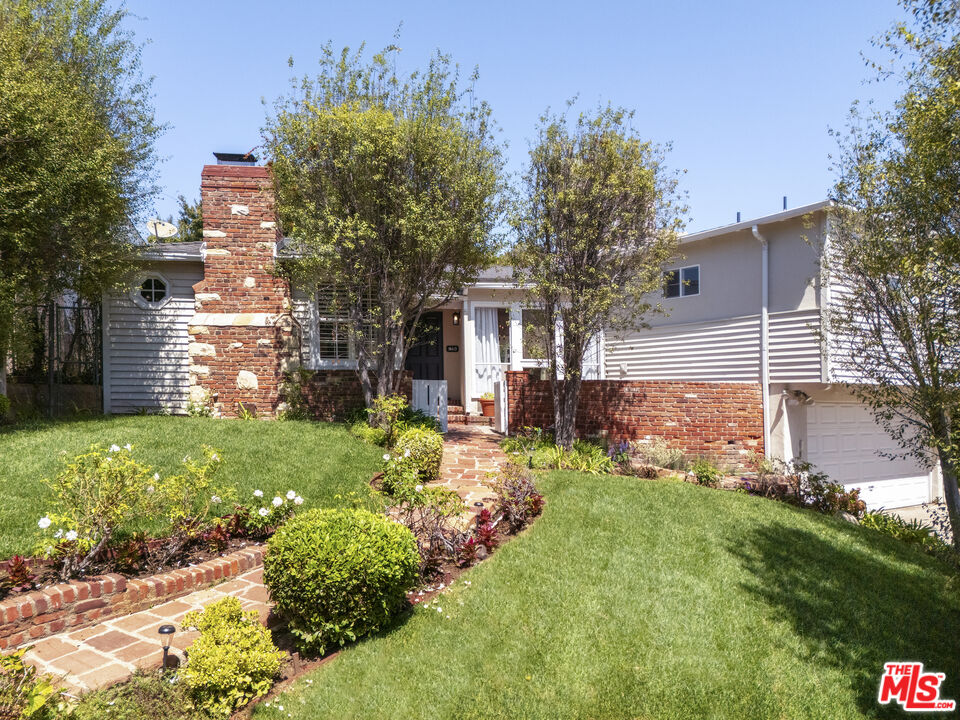 10613 Rochester Avenue Los Angeles, CA 90024 - Photo 1 of 27 a front view of a house with garden