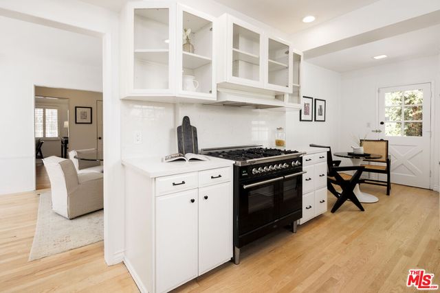 a kitchen with stainless steel appliances a stove a sink and a refrigerator