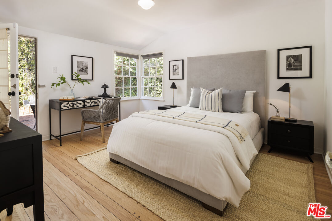 10613 Rochester Avenue Los Angeles, CA 90024 - Photo 19 of 27 a spacious bedroom with a bed and a window