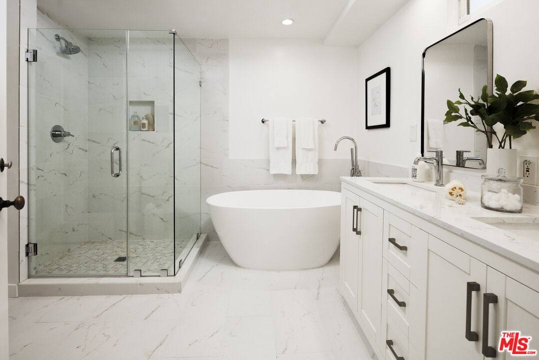 10613 Rochester Avenue Los Angeles, CA 90024 - Photo 20 of 27 a bathroom with a double vanity sink mirror and shower
