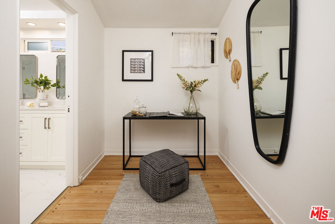 10613 Rochester Avenue Los Angeles, CA 90024 - Photo 22 of 27 a living room with furniture and a mirror