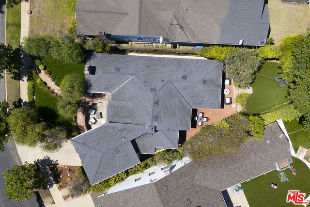 an aerial view of a house with a yard