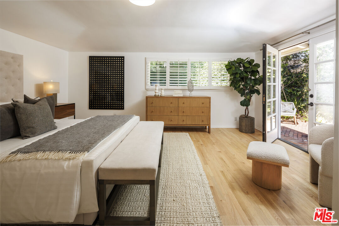 10613 Rochester Avenue Los Angeles, CA 90024 - Photo 5 of 27 a spacious bedroom with a bed and a large window