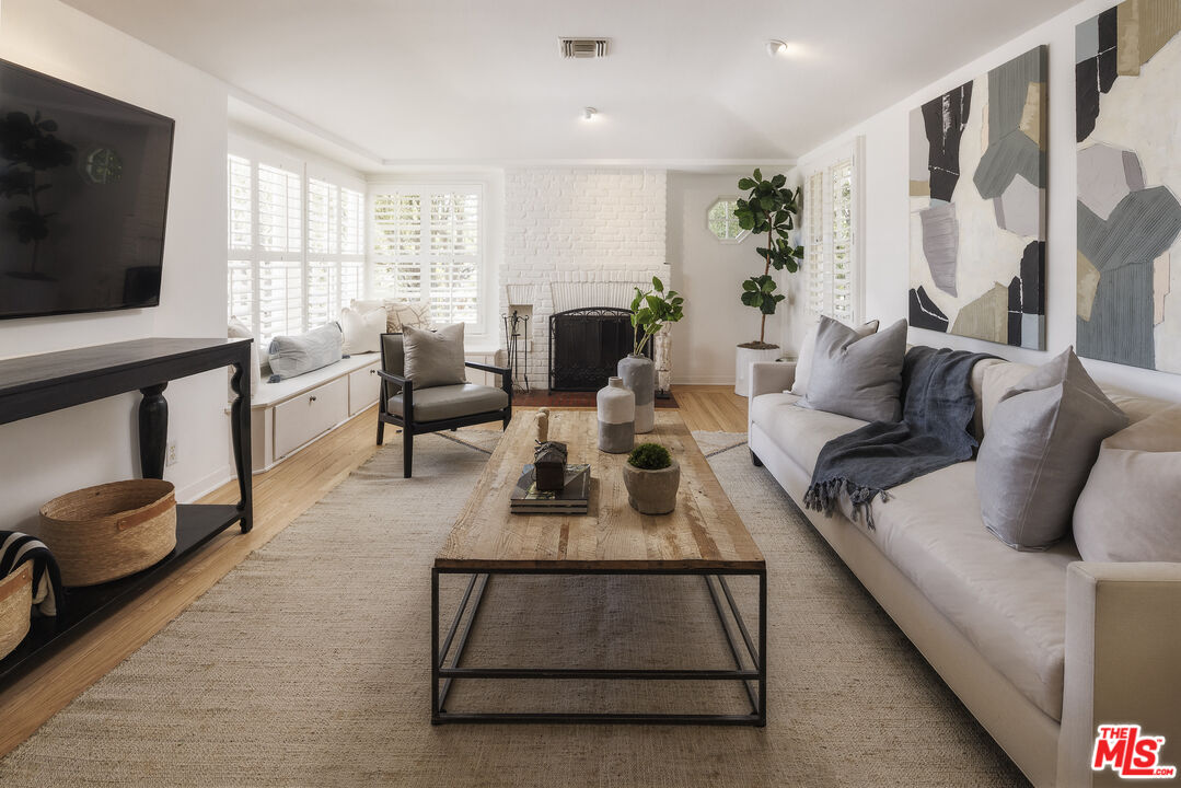 10613 Rochester Avenue Los Angeles, CA 90024 - Photo 10 of 27 a living room with furniture and a flat screen tv