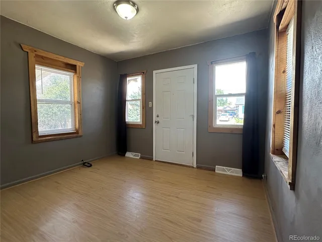 an empty room with windows and closet