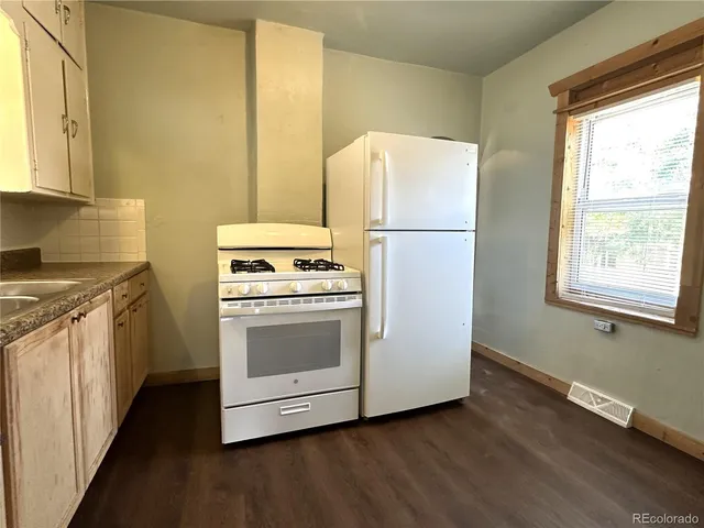 a kitchen with a refrigerator sink and stove