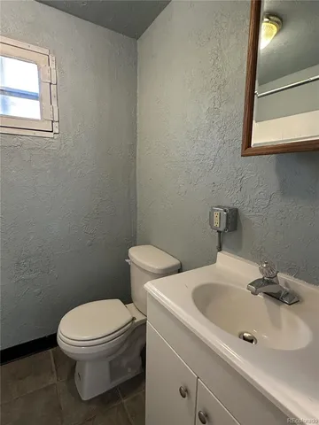 a white toilet sitting next to a bathroom sink