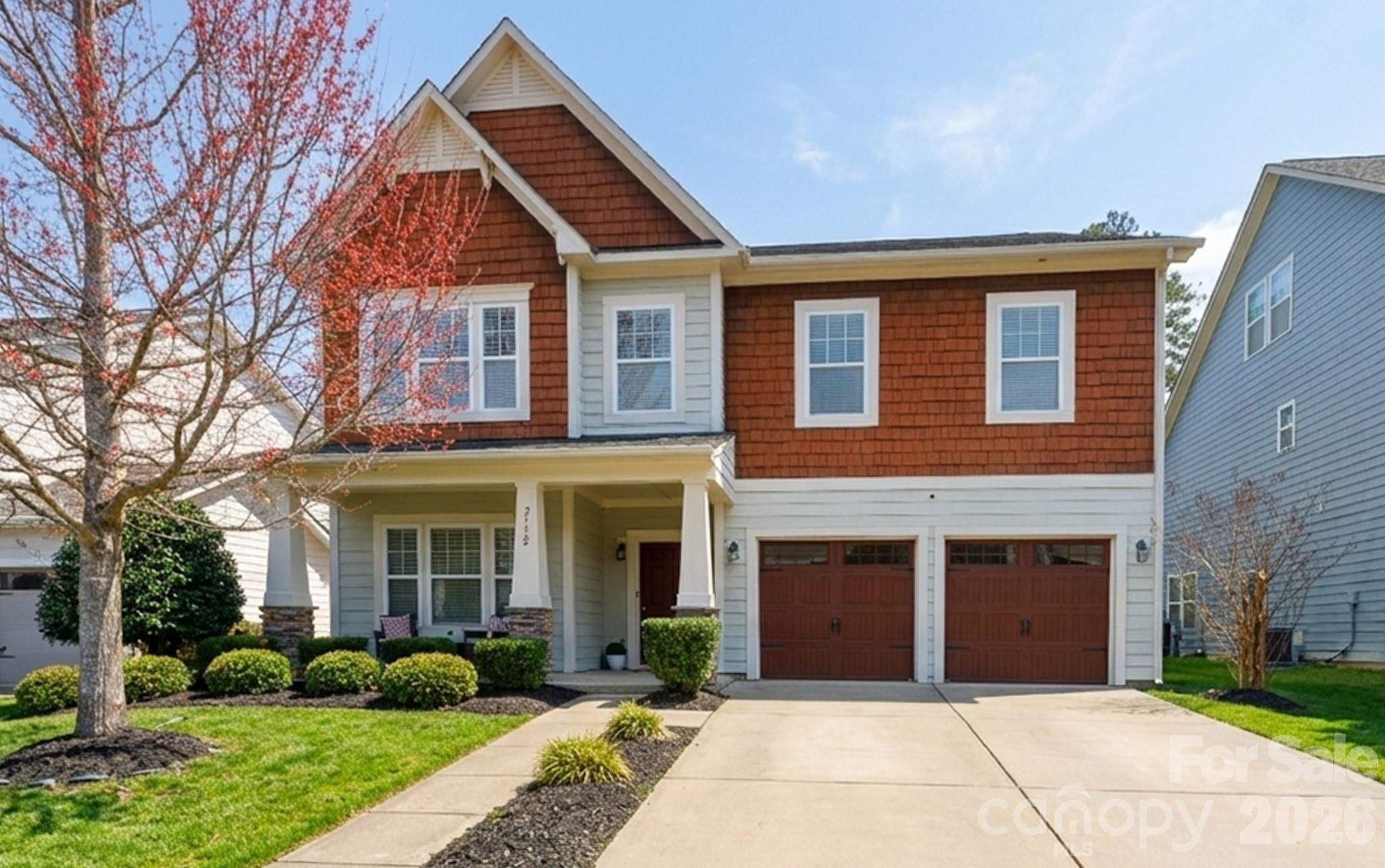 2172 Bluebell Way Tega Cay, SC 29708 - Photo 1 of 40 a front view of a house with a garden
