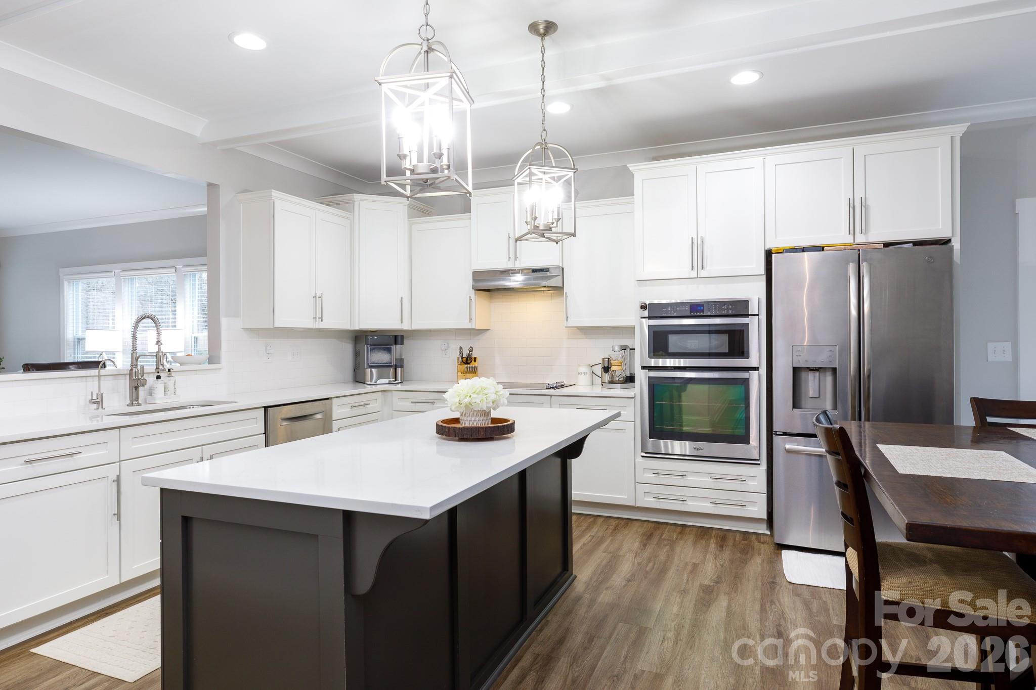 2172 Bluebell Way Tega Cay, SC 29708 - Photo 12 of 40 a kitchen with stainless steel appliances a sink stove and refrigerator