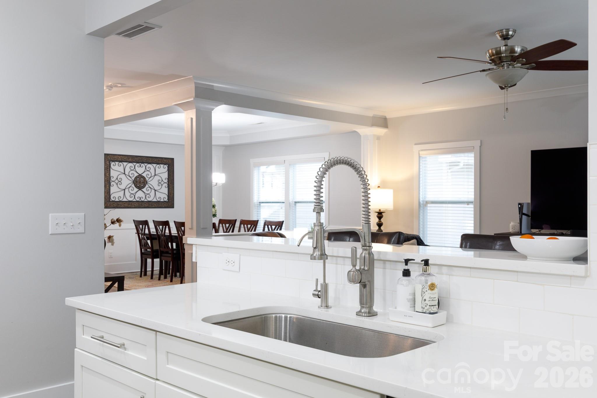 2172 Bluebell Way Tega Cay, SC 29708 - Photo 13 of 40 a kitchen with kitchen island a sink appliances and a living room