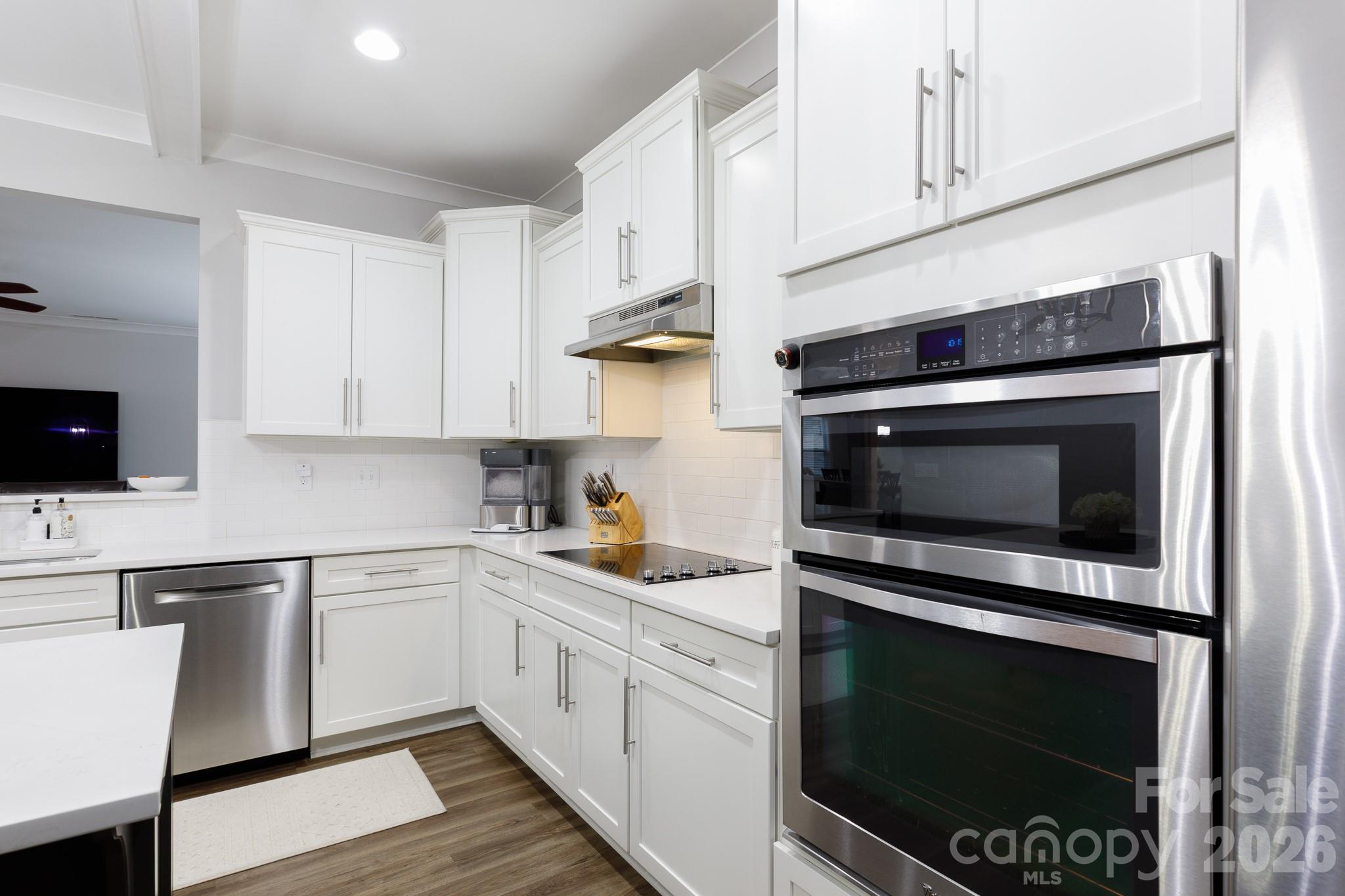 2172 Bluebell Way Tega Cay, SC 29708 - Photo 14 of 40 a kitchen with stainless steel appliances white cabinets and a stove a oven
