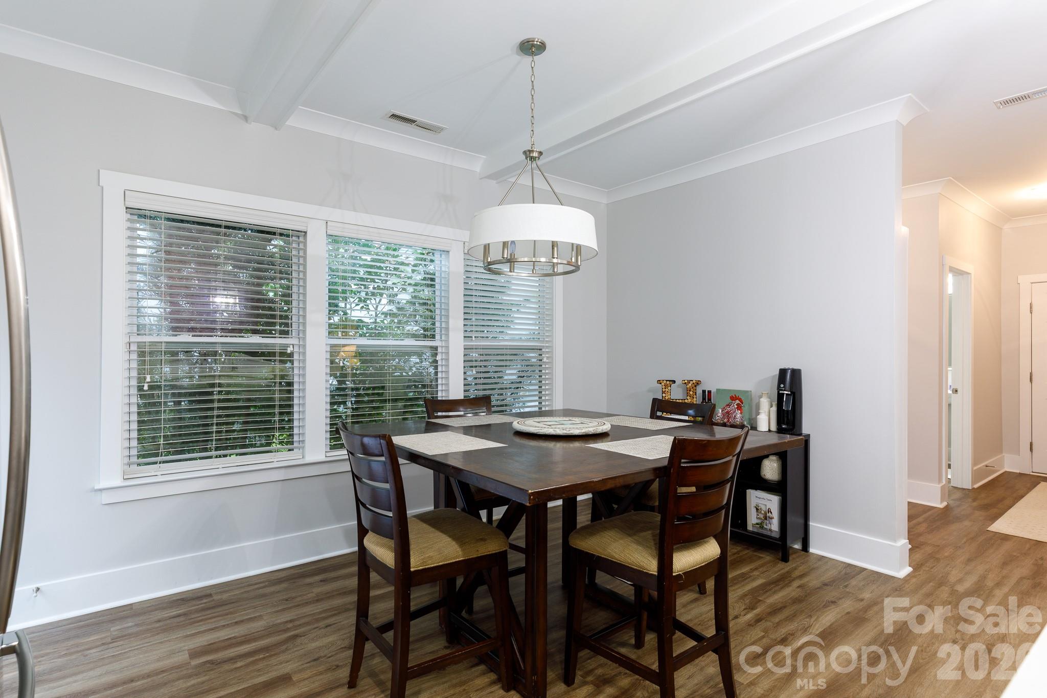 2172 Bluebell Way Tega Cay, SC 29708 - Photo 15 of 40 a dining room with furniture a chandelier and wooden floor
