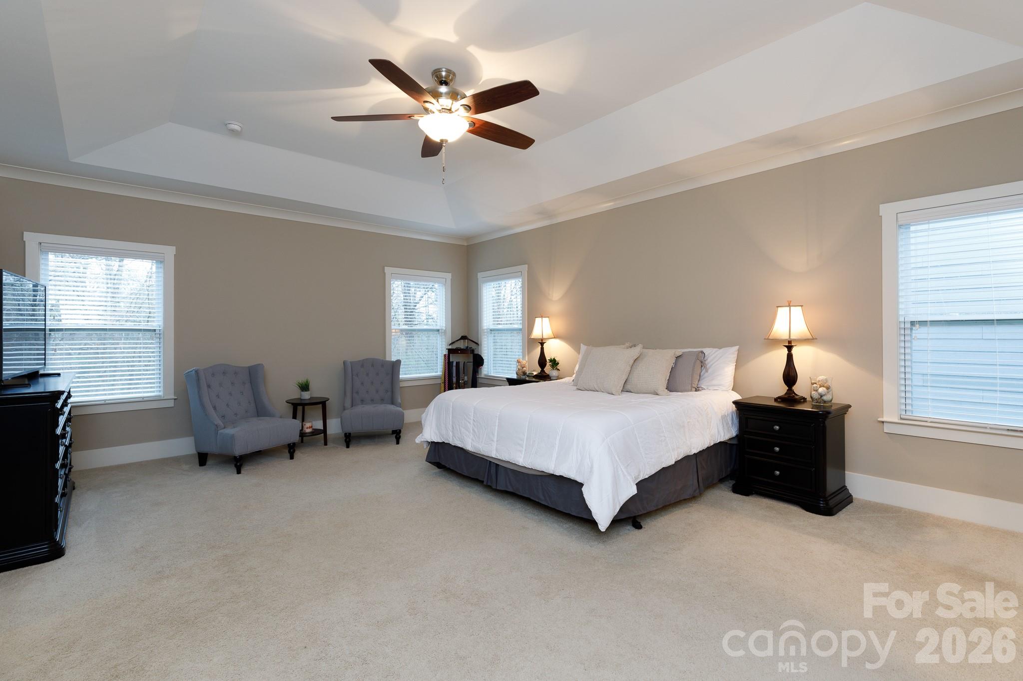 2172 Bluebell Way Tega Cay, SC 29708 - Photo 19 of 40 a spacious bedroom with a bed and a chandelier