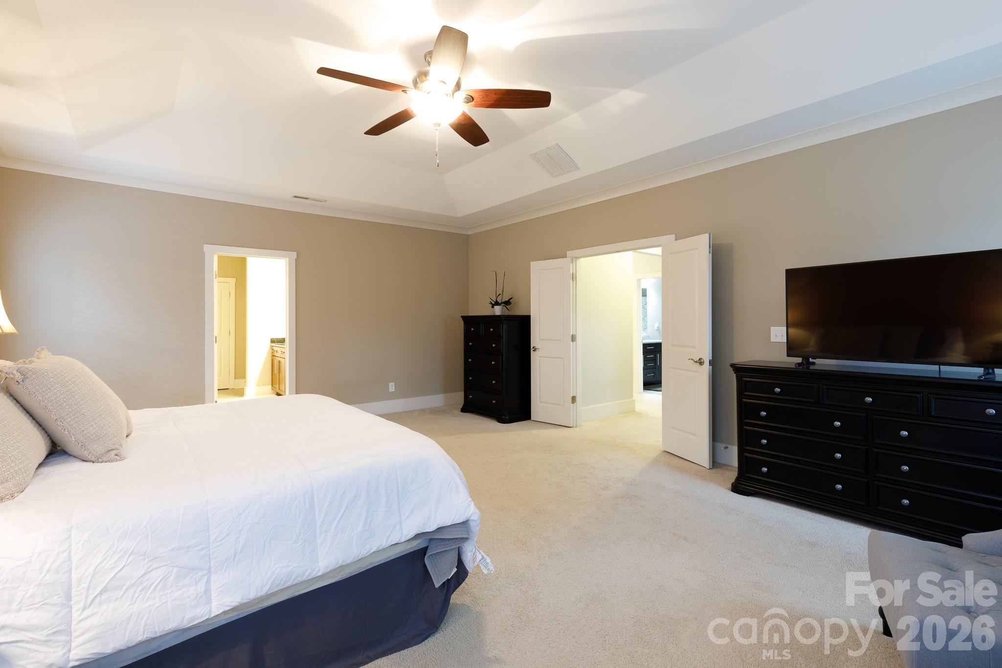 2172 Bluebell Way Tega Cay, SC 29708 - Photo 21 of 40 a bedroom with a bed and a flat screen tv