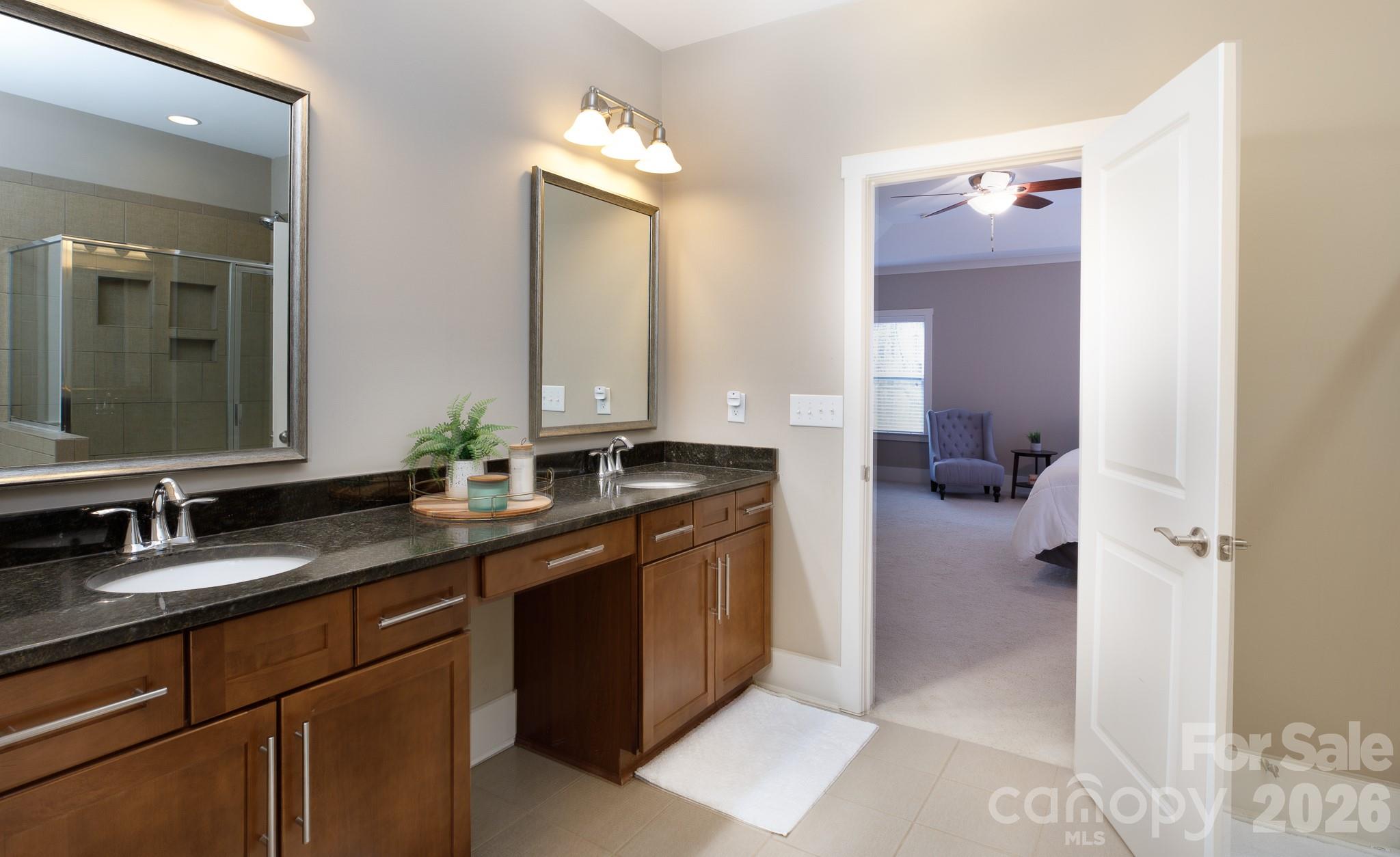 2172 Bluebell Way Tega Cay, SC 29708 - Photo 23 of 40 a bathroom with a sink and a mirror