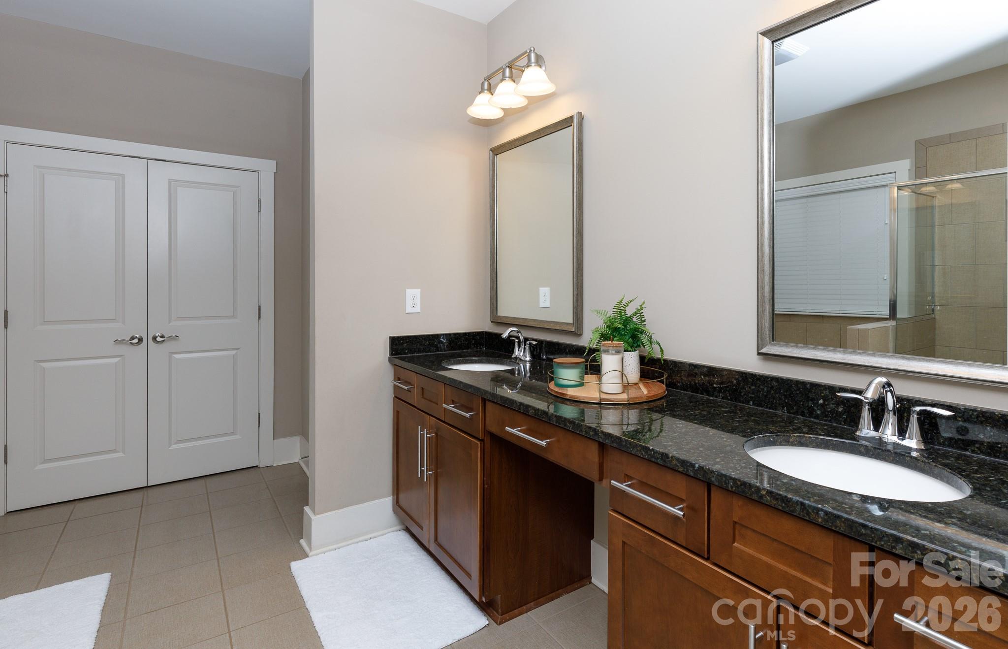 2172 Bluebell Way Tega Cay, SC 29708 - Photo 24 of 40 a bathroom with a granite countertop sink and a mirror