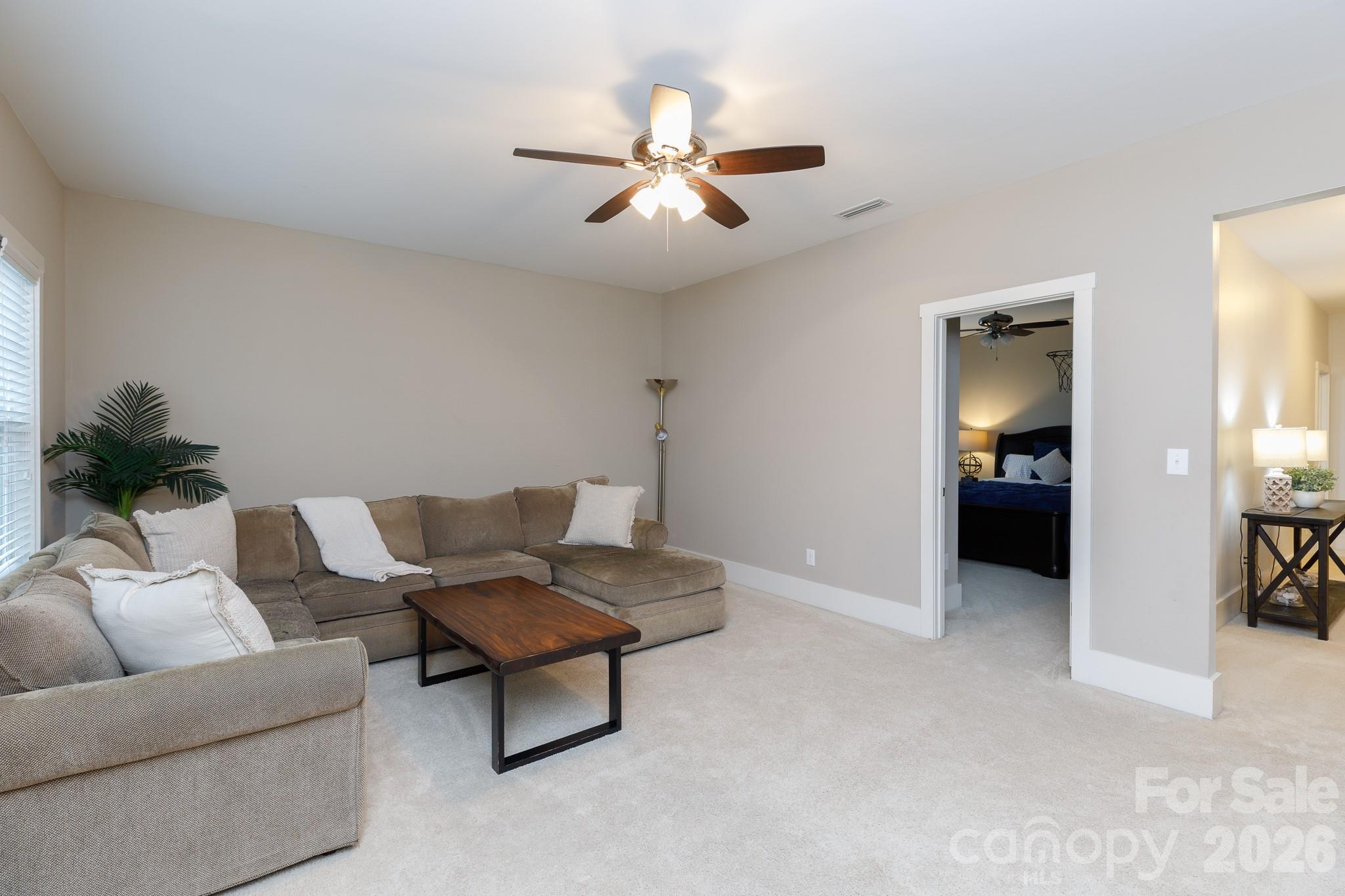 2172 Bluebell Way Tega Cay, SC 29708 - Photo 26 of 40 a living room with furniture and a chandelier