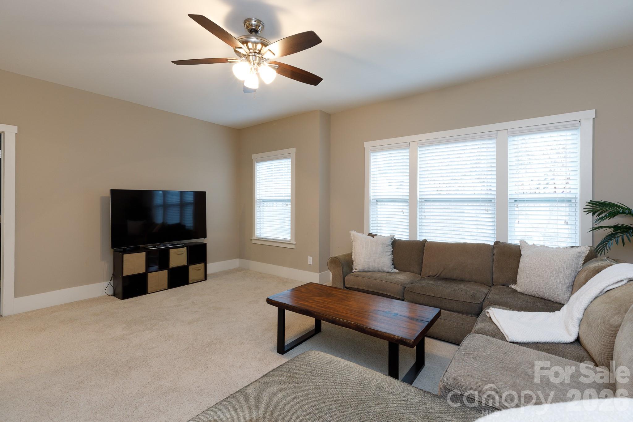 2172 Bluebell Way Tega Cay, SC 29708 - Photo 27 of 40 a living room with furniture and a flat screen tv