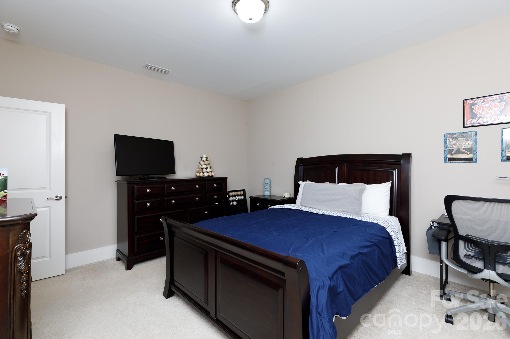 2172 Bluebell Way Tega Cay, SC 29708 - Photo 29 of 40 a bedroom with a bed and a tv on table