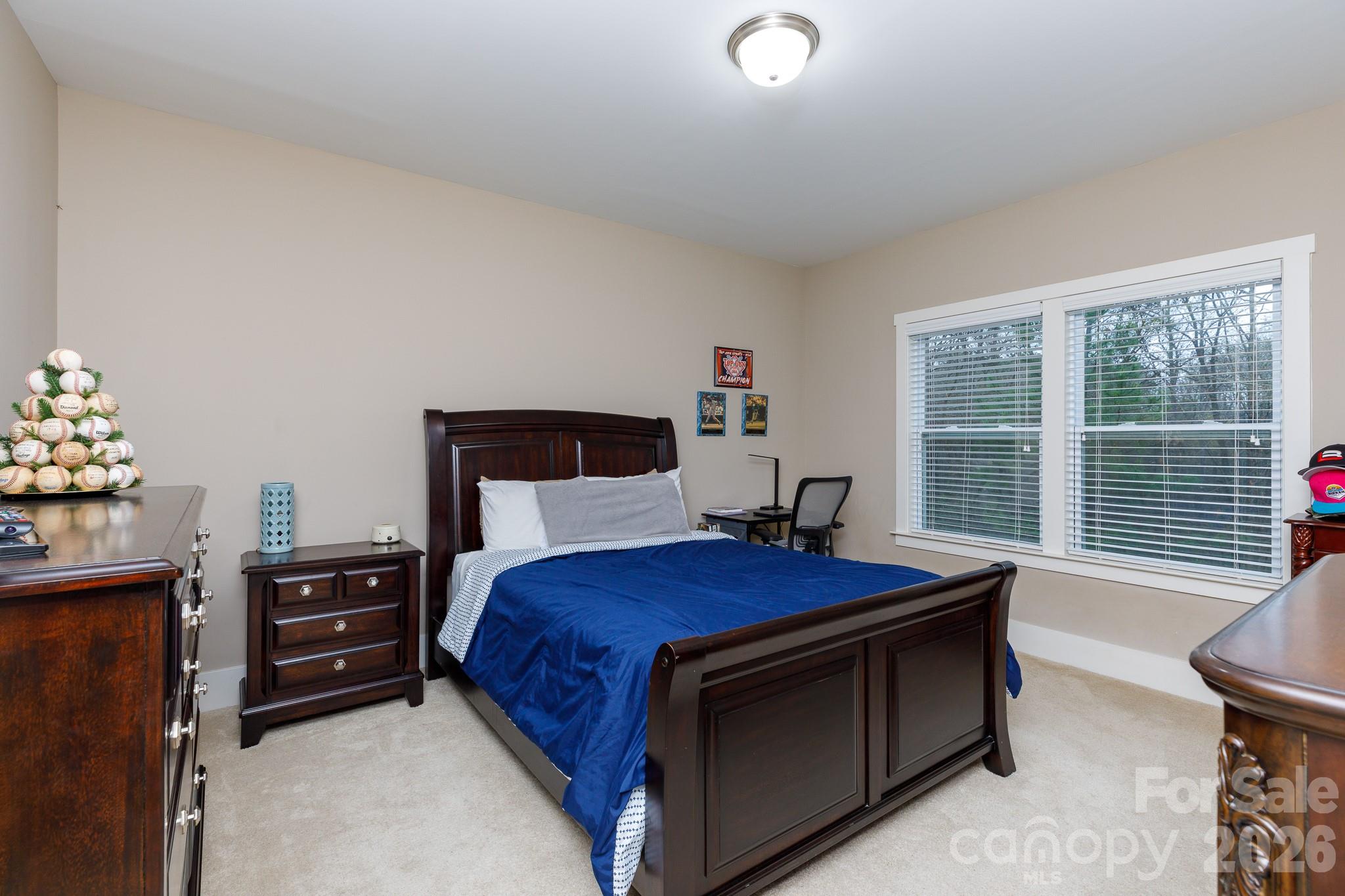 2172 Bluebell Way Tega Cay, SC 29708 - Photo 30 of 40 a bedroom with a bed and a window