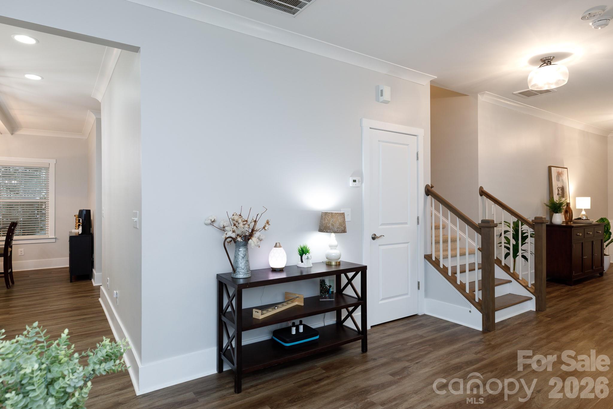 2172 Bluebell Way Tega Cay, SC 29708 - Photo 3 of 40 a view of a hallway with wooden floor and furniture