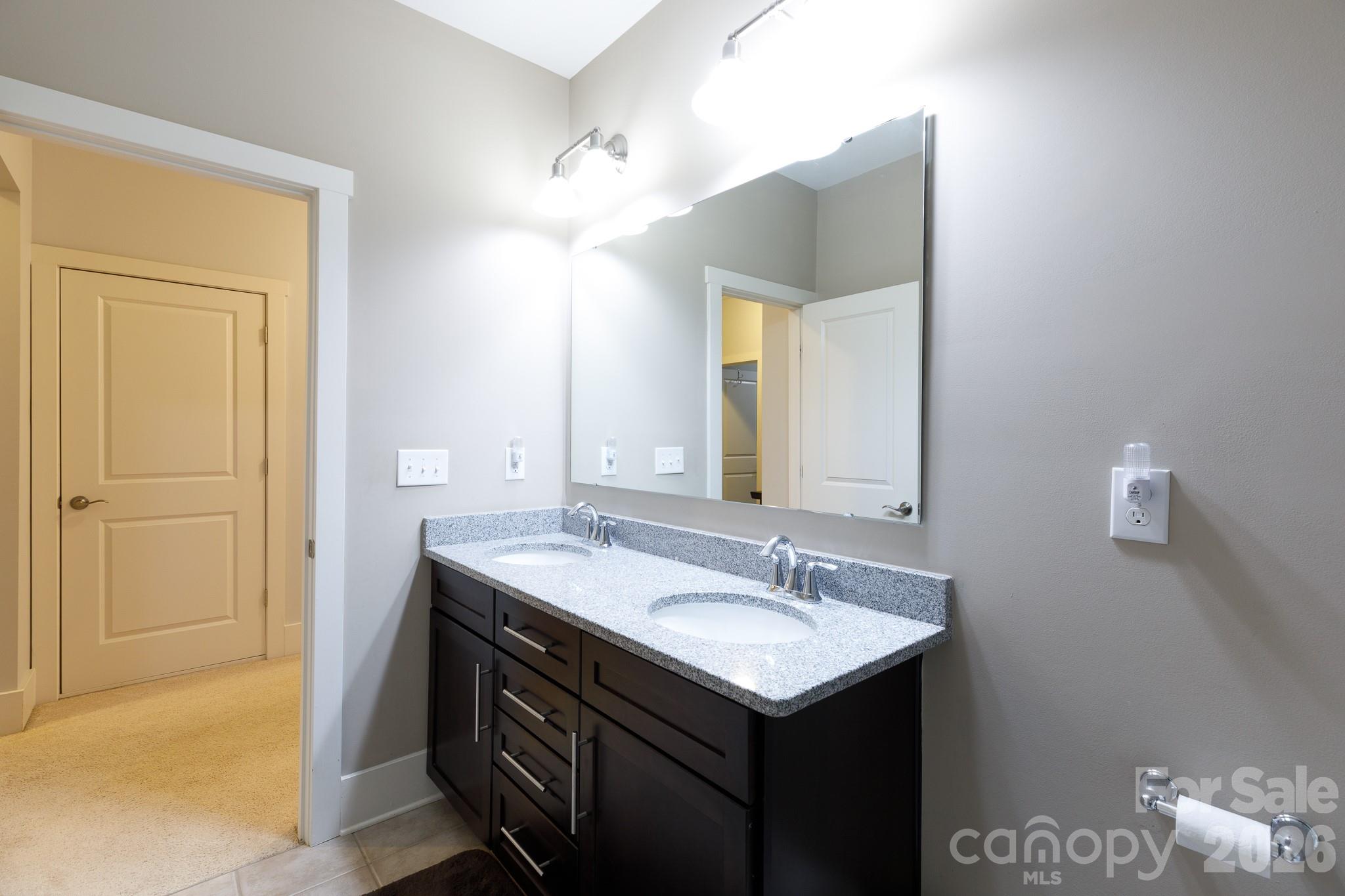 2172 Bluebell Way Tega Cay, SC 29708 - Photo 32 of 40 a bathroom with a sink and a mirror