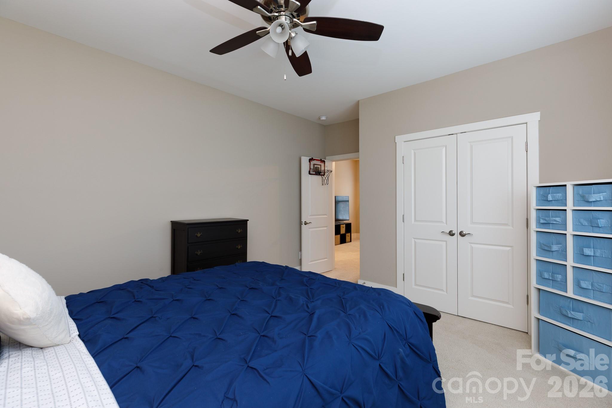 2172 Bluebell Way Tega Cay, SC 29708 - Photo 33 of 40 a bed room with a bed and a chandelier