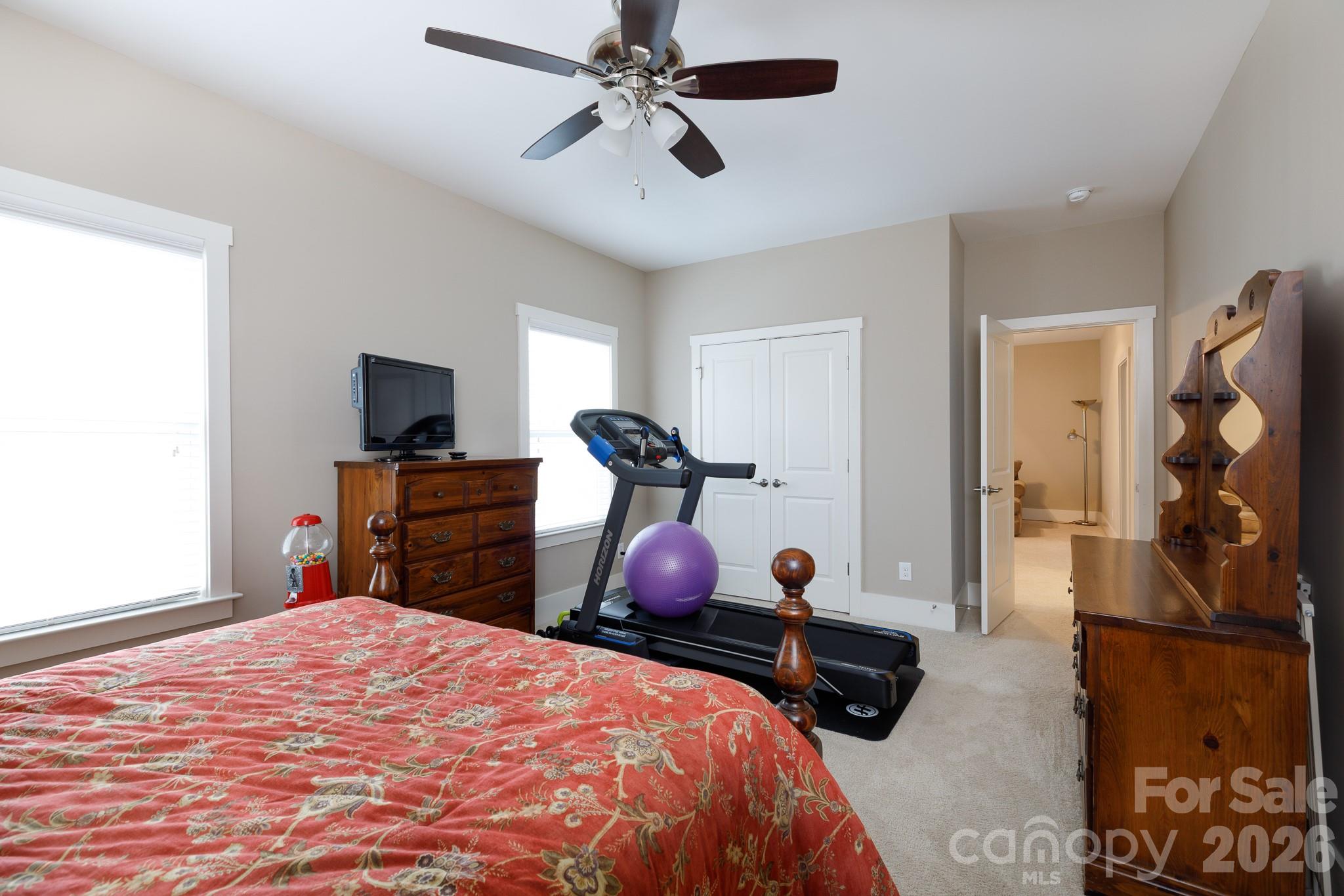 2172 Bluebell Way Tega Cay, SC 29708 - Photo 36 of 40 a bedroom with bed dresser and flat screen tv