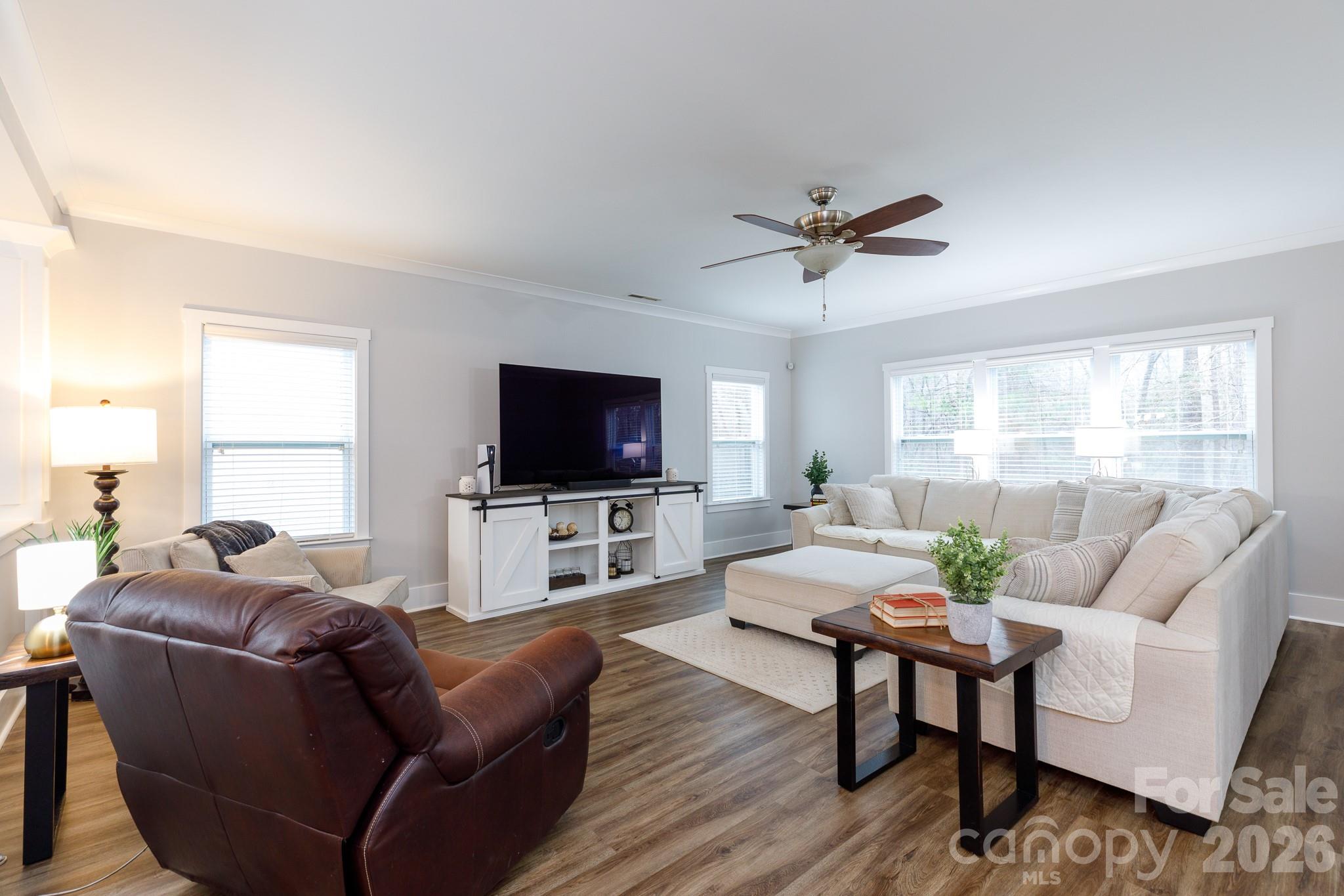 2172 Bluebell Way Tega Cay, SC 29708 - Photo 7 of 40 a living room with furniture a flat screen tv and a window