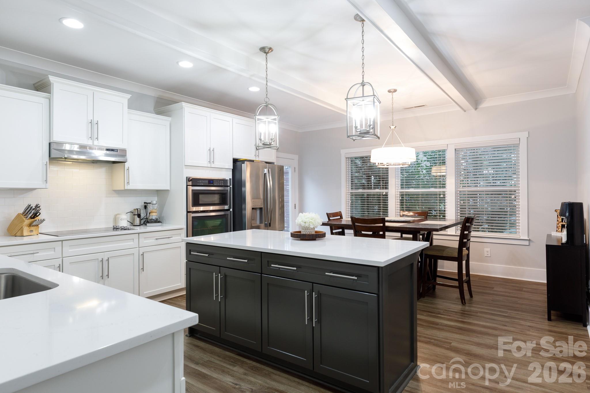2172 Bluebell Way Tega Cay, SC 29708 - Photo 10 of 40 a kitchen with stainless steel appliances granite countertop a sink a stove and a refrigerator