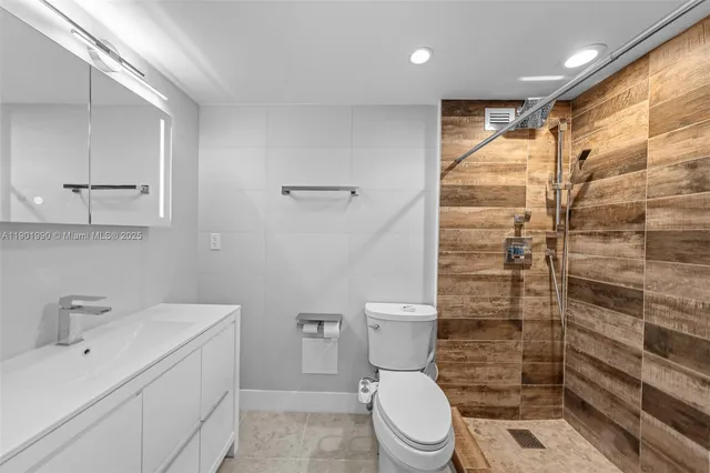 a bathroom with a toilet sink and shower