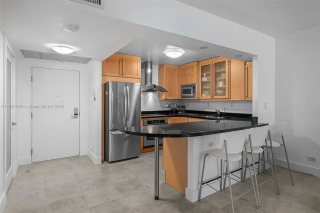 a kitchen with stainless steel appliances granite countertop a stove and a refrigerator