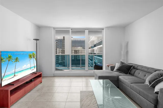 a living room with furniture and a large window