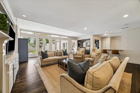 a large kitchen with stainless steel appliances kitchen island granite countertop a large counter top and a stove top oven