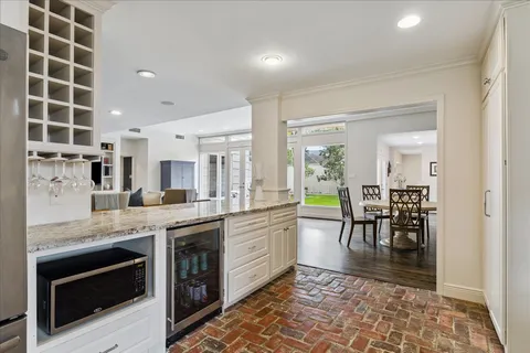 a bathroom with a granite countertop sink a toilet and a mirror