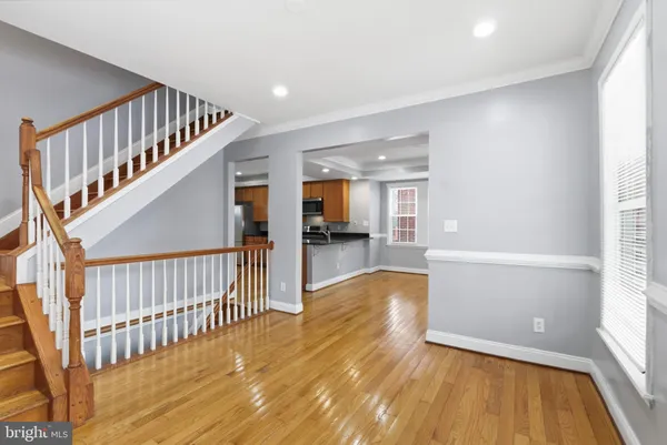 a large kitchen with stainless steel appliances granite countertop a refrigerator and a stove top oven