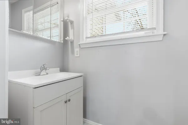 a view of a hallway with wooden floor and closet
