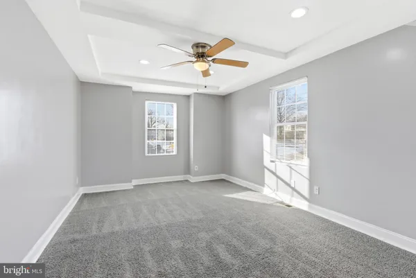 a view of empty room with ceiling fan