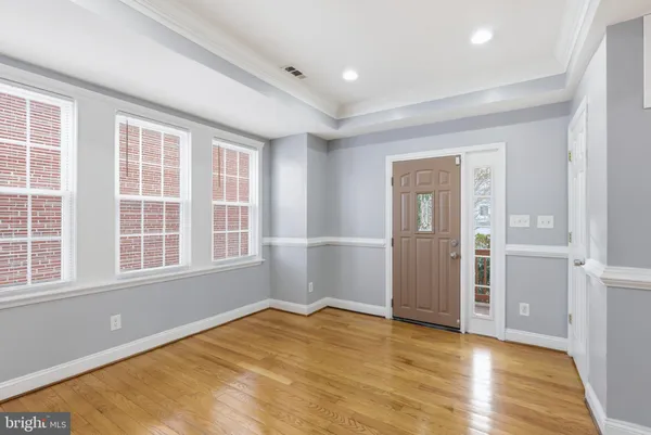 a view of kitchen and hall with wooden floor
