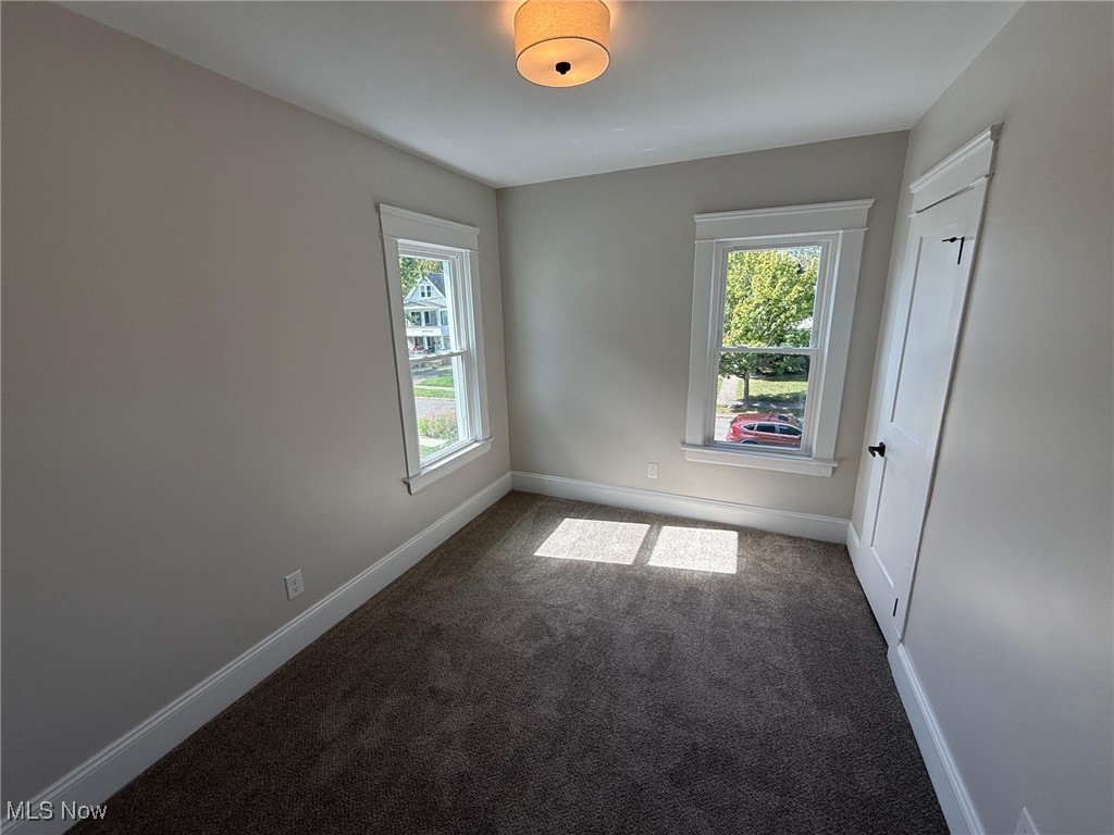 2185 Rexwood Road Cleveland, OH 44118 - Photo 13 of 26 Spare room featuring dark colored carpet and baseboards