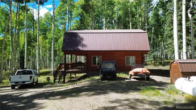 a couple of table and chairs in backyard of house