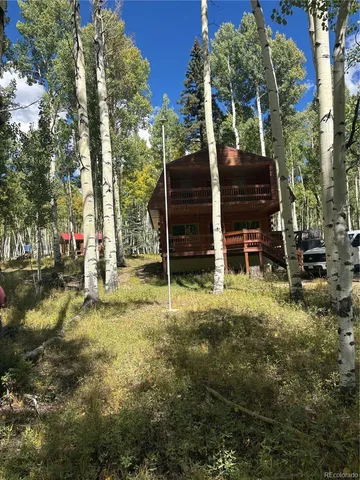 a view of a wooden deck with a yard