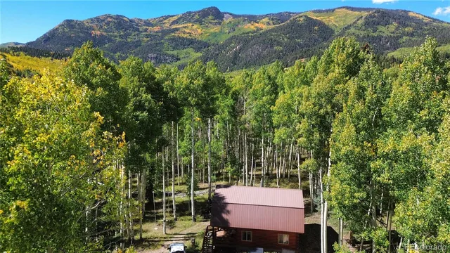 a view of a house with a wooden fence and a floor to ceiling window