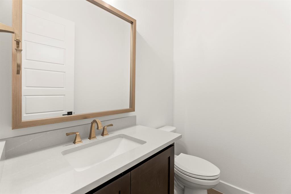 4711 Belo Drive Prosper, TX 75078 - Photo 12 of 40 a bathroom with a sink a toilet and a mirror